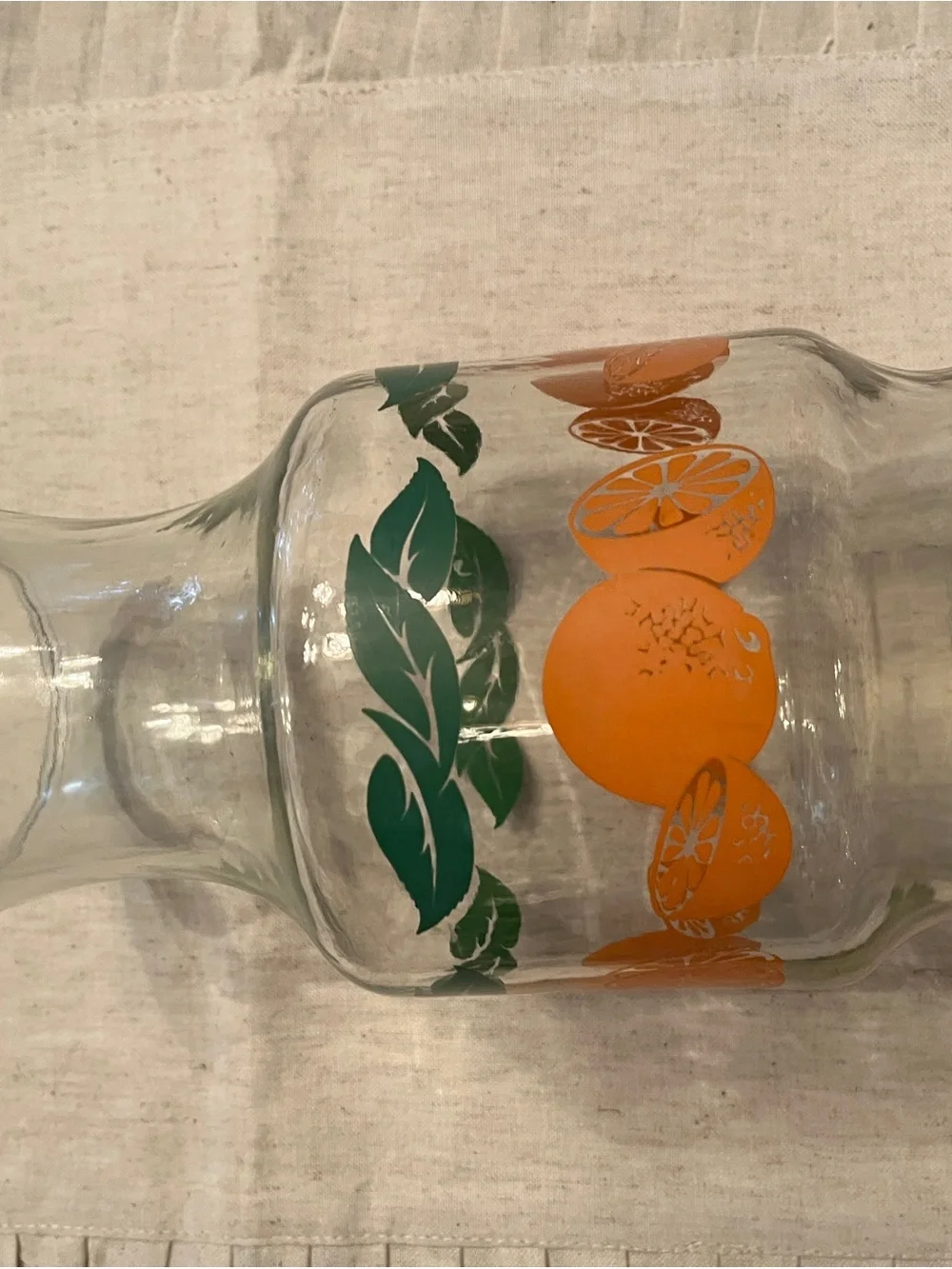 Vintage-Inspired Orange Glass Pitcher with Green Leaf Motif